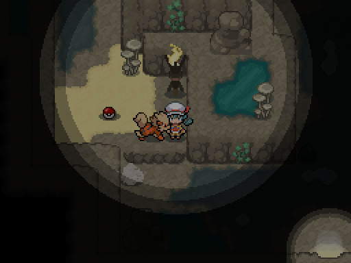 A trainer and following Pokemon are lit within a small pool of light in a dark cavern.