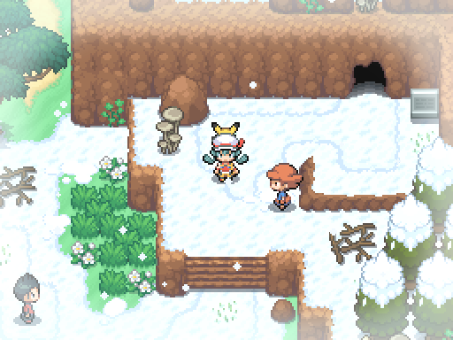A trainer stands on a snow-covered path beside a cave entrance and wooden steps.