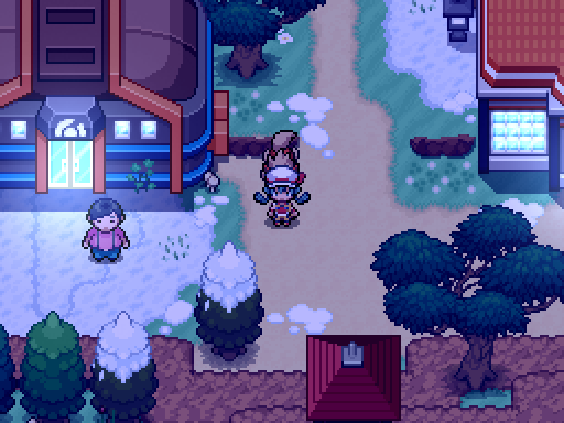 A trainer and following Pokemon pass a lit building in a snowy village at night.