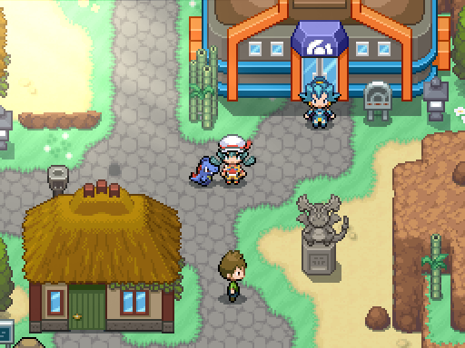 A trainer and following Pokemon pass an orange-roofed building, statues and a thatched house.